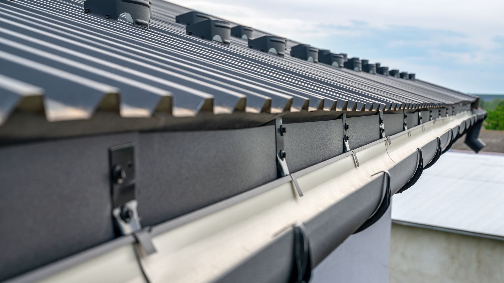 Close-up of modern metal roof with gutters and architectural detail