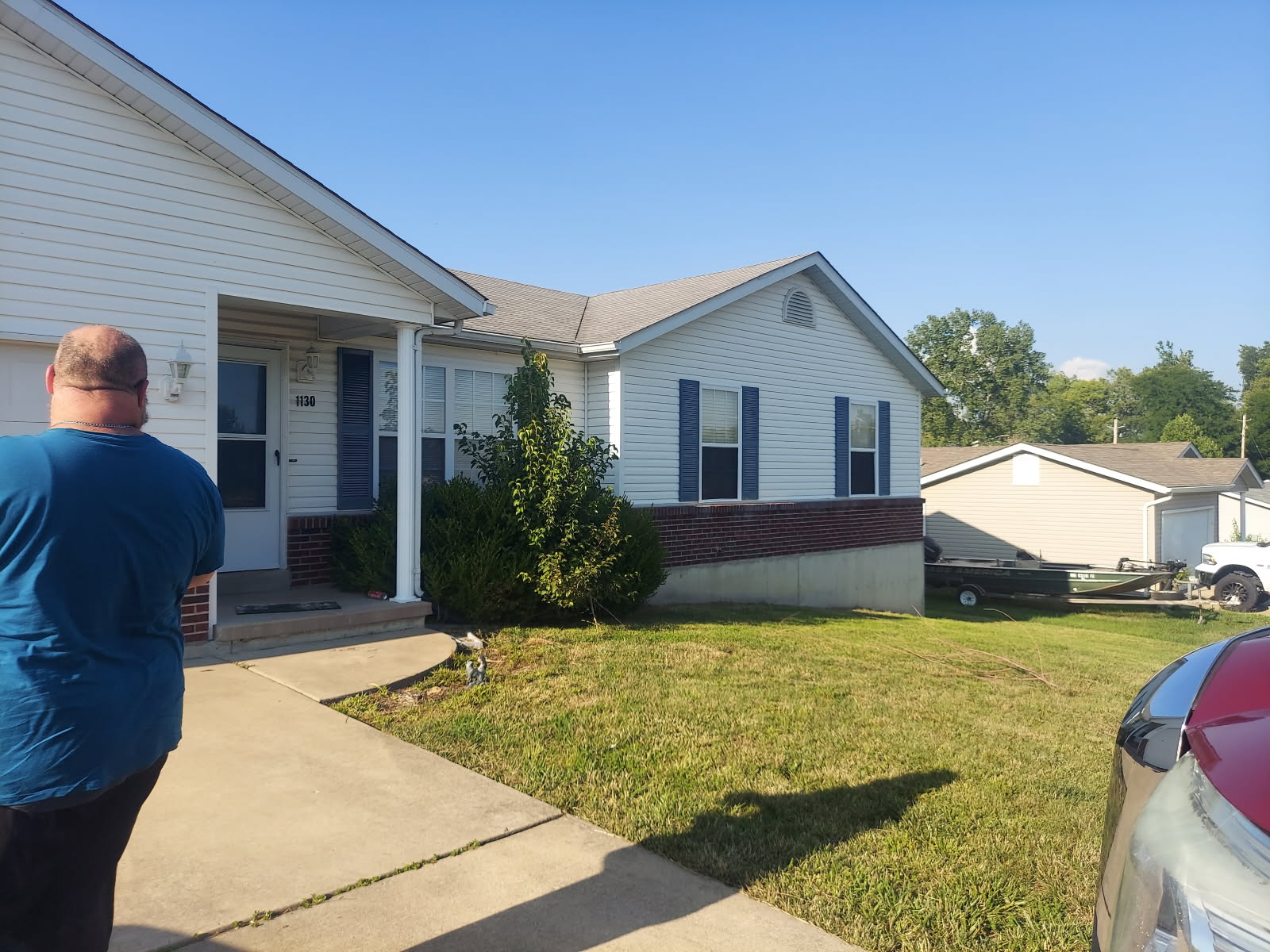 White suburban house with blue shutters on a sunny day